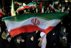 War-time march: People wave national flags and hold portraits of Iran&rsquo;s supreme leader Mojtaba Khamenei on Wednesday, March 25, 2026, as they march in support of the Iranian armed forces in central Tehran.