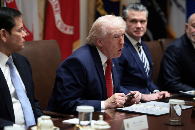 US President Donald Trump holds a Sharpie pen that was custom-made for the White House, during a cabinet meeting at the White House in Washington on March 26, 2026.