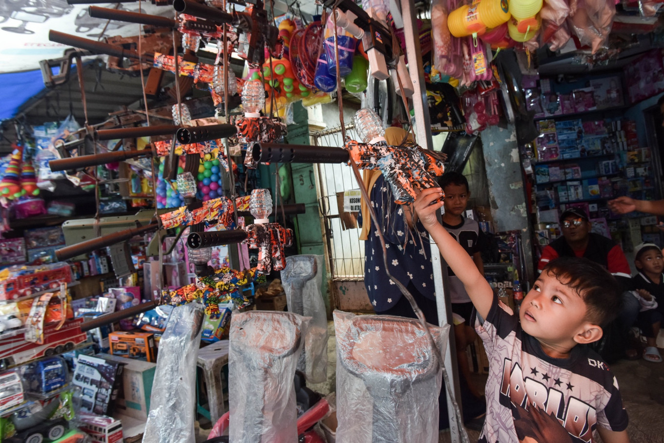 A boy reaches for a toy on March 23, 2026, at Gembrong Market in Jatinegara, East Jakarta.