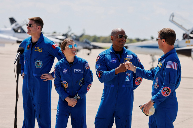 NASA astronauts Reid Wiseman (right) and Victor Glover (second right) greet each other next to NASA astronaut Christina Koch (second left) and Canadian Space Agency (CSA) astronaut Jeremy Hansen (left) at Kennedy Space Centre in Cape Canaveral, Florida, the United States on March 27, 2026, ahead of the Artemis II launch.