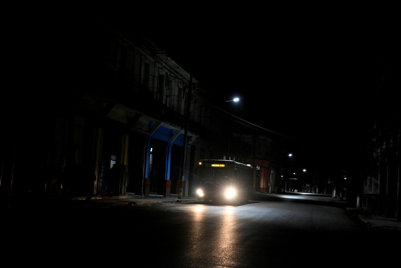 In this file photo dated March 22, 2026, a bus drives along a dark street as Cuba begins efforts to restore power after its grid collapsed for the second time in a week amid a US oil blockade that has dealt a major blow to the island's already ailing energy infrastructure in Havana, Cuba. 