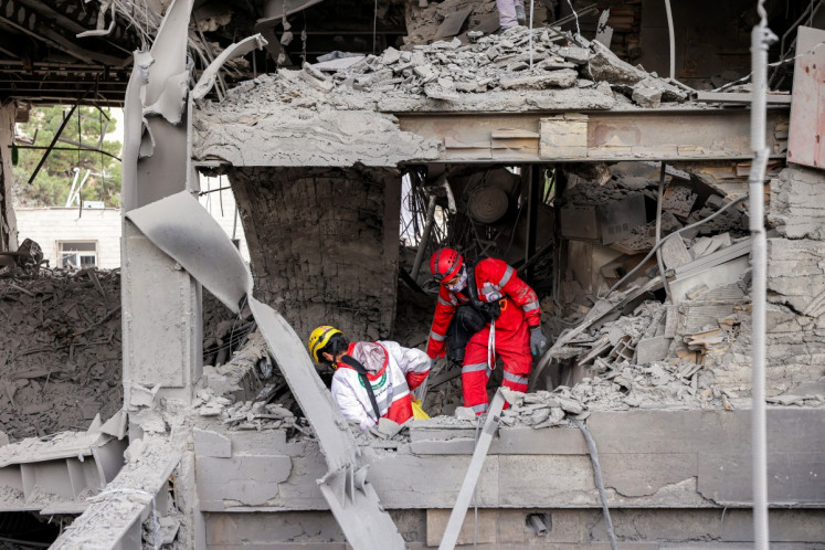 First responders search an office building that housed the offices of the Doha-headquartered news network Al Araby TV following a missile strike earlier in the day in Tehran on March 29, 2026. The network on March 29 criticized a strike on the building hosting its Tehran office, as Israel and the US pressed an aerial campaign against Iran. It added that, according to the Iranian Red Crescent, 10 people had been injured in the Sunday morning strike.