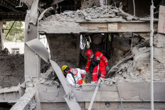 First responders search an office building that housed the offices of the Doha-headquartered news network Al Araby TV following a missile strike earlier in the day in Tehran on March 29, 2026. The network on March 29 criticized a strike on the building hosting its Tehran office, as Israel and the US pressed an aerial campaign against Iran. It added that, according to the Iranian Red Crescent, 10 people had been injured in the Sunday morning strike.