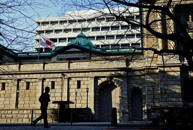 A passerby walks past the Bank of Japan headquarters in Tokyo on Jan. 23, 2025.