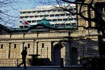 A passerby walks past the Bank of Japan headquarters in Tokyo on Jan. 23, 2025.