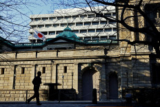A passerby walks past the Bank of Japan headquarters in Tokyo on Jan. 23, 2025.