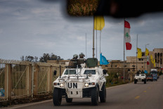 A United Nations Interim Force in Lebanon (UNIFIL) convoy drives on March 23 near the southern Lebanese city of Tyre. The Israeli military said it launched a wave of strikes on Beirut targeting the Iran-backed militant group Hezbollah, after urging residents of several areas to evacuate.