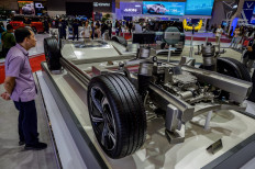 A man stands next to the chassis of an electric vehicle on July 18 at the Gaikindo Indonesia International Auto Show (GIIAS) 2024, which ran until July 28 at the Indonesia Convention Exhibition in Tangerang, Banten. 