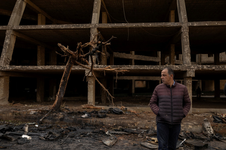 A man stands on the impact site of an Israeli strike on April 1, 20226, amid escalating hostilities between Israel and Hezbollah, as the United States-Israel war on Iran continues, in Beirut, Lebanon.