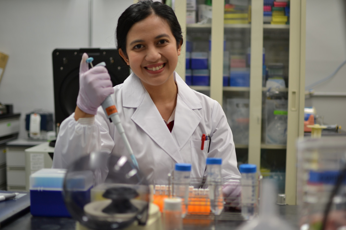 Intersystem facilitator: Indonesian biotechnologist Sastia Prama Putri conducts research in a laboratory at the University of Osaka in Japan, in this undated handout photo.