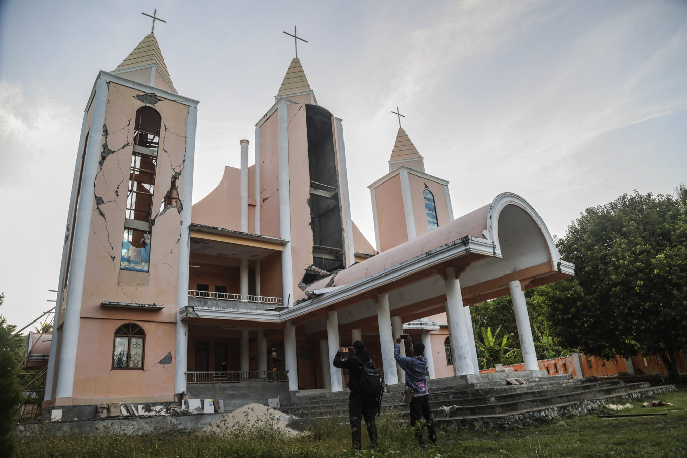 Journalists take picture of a church in Ternate, North Maluku, on April 3, 2026 that was damaged during an earthquake in the Maluku Sea the previous day.
