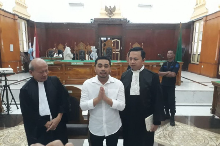 Amsal Christy Sitepu (center) is flanked by his defense lawyers while giving a statement to journalists after the Medan District Court in North Sumatra acquitted him of all charges on April 1, 2026. Prosecutors had accused him of marking up budgets in his proposal to make profile videos for 20 villages in Karo regency, North Sumatra, from 2020 to 2022. 