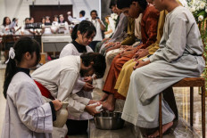 Service and humility: A Catholic congregant washes the feet of his fellow believers on April 2, 2026 during a ritual highlighting the Maundy Thursday Eucharist at Bongsari Church in Semarang, Central Java. 