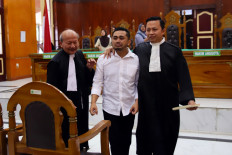Amsal Christiy Sitepu (center) weeps after his verdict hearing on April 1, 2026, at the Medan District Court in North Sumatra in a case related to the production of village profile videos. The panel of judges acquitted the videographer of all charges.