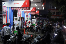 Motorists queue on March 31, 2026, to refuel at a gas station owned by state-owned oil and gas company Pertamina in Depok, West Java, as the government announced limits on subsidized fuel sales to counter the impact of the United States-Israeli war on Iran.