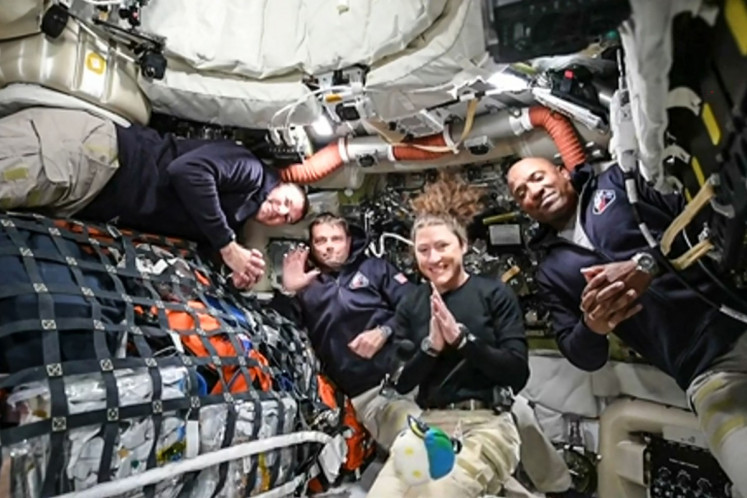 This screen grab from NASA's feed released on April 3, 2026, shows the four Artemis II crew members (from left to right) Canadian Space Agency (CSA) astronaut and Artemis II mission specialist Jeremy Hansen, Artemis II commander Reid Wiseman of NASA, Artemis II mission specialist Christina Koch of NASA and Artemis II pilot Victor Glover of NASA as they head to orbit the Moon for the first time in more than half a century. The spacecraft lifted off from Kennedy Space Center in Florida at 6:35 p.m. Eastern time the previous day.