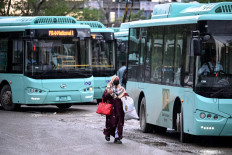 A woman passenger arrives at a government bus stop in Islamabad, Pakistan on April 3, 2026. State-run public transport in Pakistan's capital and most populous province will be free for the coming month, officials said on April 3, after the government drastically raised fuel prices due to spiking global energy prices caused by the Iran war.