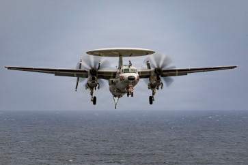 This US Navy handout photo released on March 18, 2026 by US Central Command public affairs, shows an E-2D Hawkeye aircraft, attached to Airborne Command and Control Squadron 124, preparing to land on the flight deck of the world's largest aircraft carrier, USS Gerald R. Ford (CVN 78), during Operation Epic Fury, on March 15, 2026. 