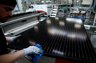 An employee works on a solar panel production line at the Systovi factory in Carquefou near Nantes, France, on March 29, 2024.
