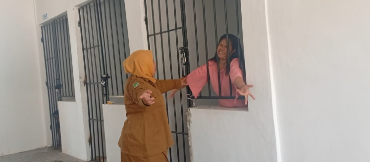An official from the Batam Social Affairs and Society Empowerment Agency (left) checks the condition of a mentally ill person on April 6, 2026, at the agency's shelter in Sekupang, Batam city, Riau Islands. The city will trace the identity of mentally ill people and homeless people using fingerprints and those from outside Batam will be returned to their hometowns. 