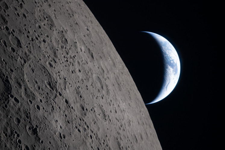 This handout picture released on April 7, 2026, by NASA shows crescent Earth setting along the Moon's limb, as seen from the Orion spacecraft on April 6, 2026. The edge of the visible surface of the Moon is called the &ldquo;lunar limb&ldquo;. 