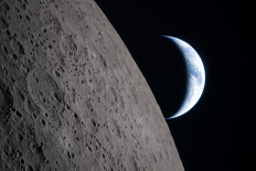 This handout picture released on April 7, 2026, by NASA shows crescent Earth setting along the Moon's limb, as seen from the Orion spacecraft on April 6, 2026. The edge of the visible surface of the Moon is called the &ldquo;lunar limb&ldquo;. The Artemis II astronauts wrapped up their lunar flyby as they continue their journey back to Earth on Tuesday, bringing with them rich celestial observations including little-known lunar craters, a solar eclipse and meteor strikes that scientists hope will open doors. 