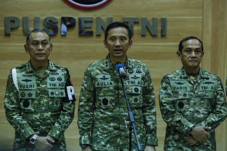 Indonesian Military (TNI) spokesperson Maj. Gen. Aulia Dwi Nasrullah (center), accompanied by TNI Police Headquarters (Puspom) commander Maj. Gen. Yusri Nuryanto (left) and TNI legal division chief Rear Adm. Farid Ma'ruf (right), speaks to journalists on March 25, 2026, during a press briefing at the TNI's headquarters in Cilangkap, East Jakarta. During the press briefing, Aulia announced the resignation of TNI Strategic Intelligence Agency (BAIS) chief Lt. Gen. Yudi Abrimantyo amid the investigation into BAIS linked personnel for the acid attack against Andrie Yunus in Jakarta on March 12. 