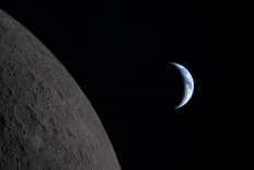 This handout picture released on April 7, 2026, by NASA shows Earth drawing closer to passing behind the Moon, about six minutes before &ldquo;Earthset,&ldquo; as seen from the Orion spacecraft on April 6, 2026. 