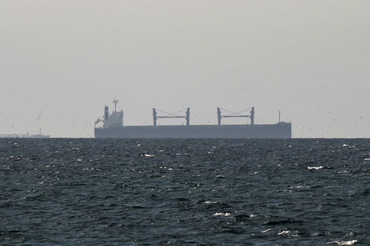 A cargo ship in the Gulf, near the Strait of Hormuz, as seen from northern Ras al-Khaimah, near the border with Oman&rsquo;s Musandam governance, in United Arab Emirates, March 11, 2026. 