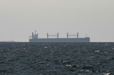 A cargo ship in the Gulf, near the Strait of Hormuz, as seen from northern Ras al-Khaimah, near the border with Oman&rsquo;s Musandam governance, in United Arab Emirates, March 11, 2026. 
