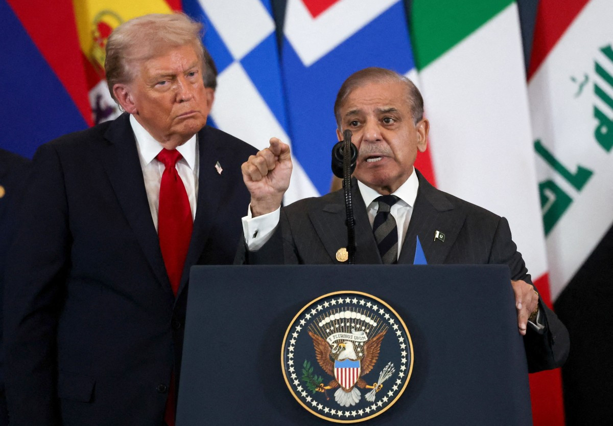 Pakistani Prime Minister Shehbaz Sharif (right) speaks as US President Donald Trump listens during the Gaza summit in Sharm El-Sheikh on October 13, 2025. 