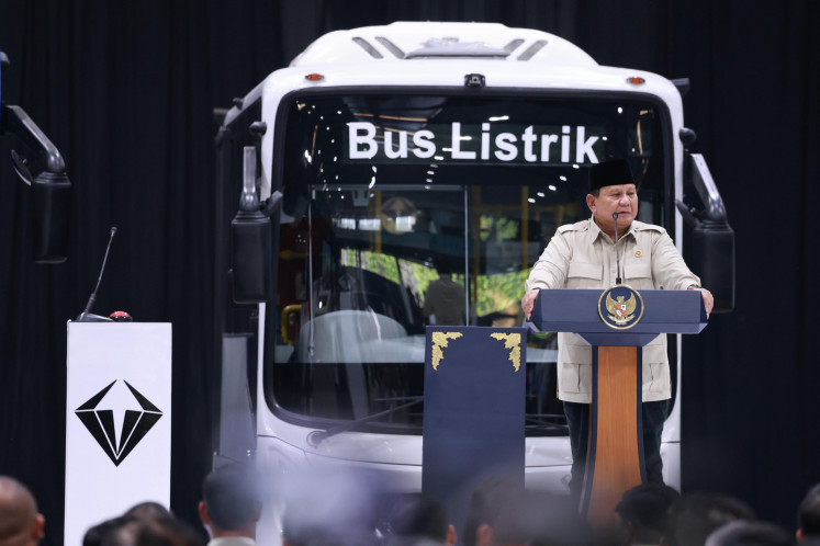 President Prabowo Subianto gestures as he stands in front of an electric bus during the inauguration of the country&rsquo;s first assembly plant for large commercial vehicles operated by PT VKTR Sakti Industries in Magelang, Central Java, on April 9, 2026.

