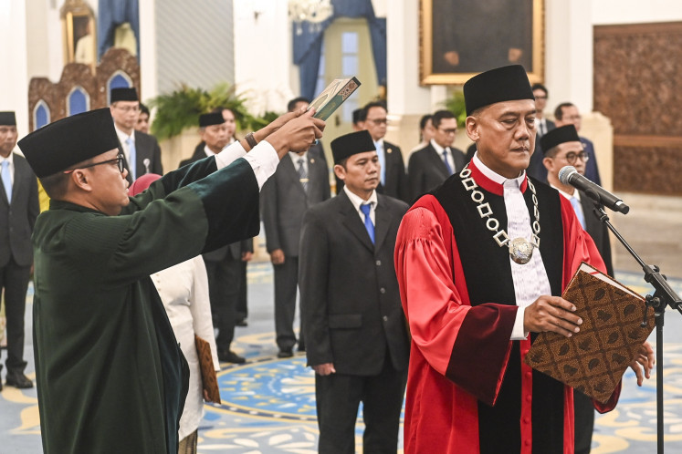 Constitutional Court Justice Liliek Prisbawono Adi (right) takes the oath of office on April 10, 2026 during his inauguration ceremony at the State Palace in Jakarta. Liliek replace former justice Anwar Usman who, retired after serving 15 years on the Constitutional Court.