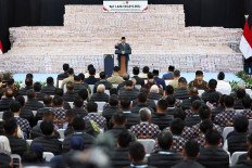 President Prabowo Subianto gestures on Friday while delivering a speech in front of stacks of rupiah banknotes representing fines paid by companies found to have operated illegally in forest areas during a ceremony at the Attorney General's Office (AGO) building in Jakarta. During the ceremony, the President also expressed his appreciation the work of the Forest Enforcement Task Force (Satgas PKH) in reclaiming forest areas that are used by plantation and mining companies.