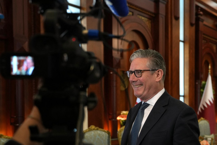 Britain's Prime Minister Keir Starmer speaks to the media at the airport in Doha, Qatar on April 10, 2026.