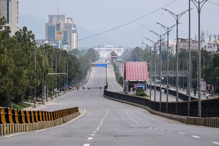 A deserted road leading to the Red Zone area is pictured after authorities restricted movement ahead of US-Iran peace talks in Islamabad on April 11, 2026.