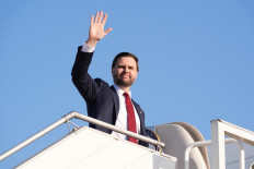 US Vice President JD Vance waves as he boards Air Force Two after attending talks on Iran in Islamabad on April 12, 2026. 