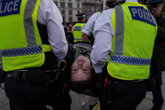 Police carry away a protester as people gather to call for the lifting of the ban on the Palestine Action group during a demonstration in Trafalgar Square in central London on April 11, 2026. Britain's Prime Minister Keir Starmer's Labor government banned Palestine Action as a terrorist organization in 2025, making it a criminal offence to belong to or support the group.