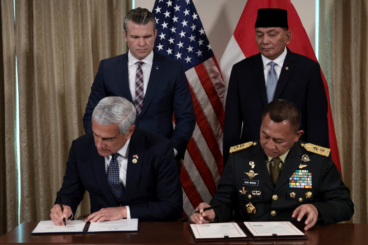 United States Secretary of Defense Pete Hegseth (left, rear) and Indonesian Defense Minister Sjafrie Sjamsoeddin (right, rear) serve as witnesses on April 13, 2026, during a signing ceremony at the Pentagon in Arlington, Virginia, just outside of Washington, D.C.