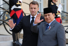 President Prabowo Subianto (right) is welcomed by French President Emmanuel Macron on April 14, 2026, prior to their meeting at the Elysee Presidential Palace in Paris.