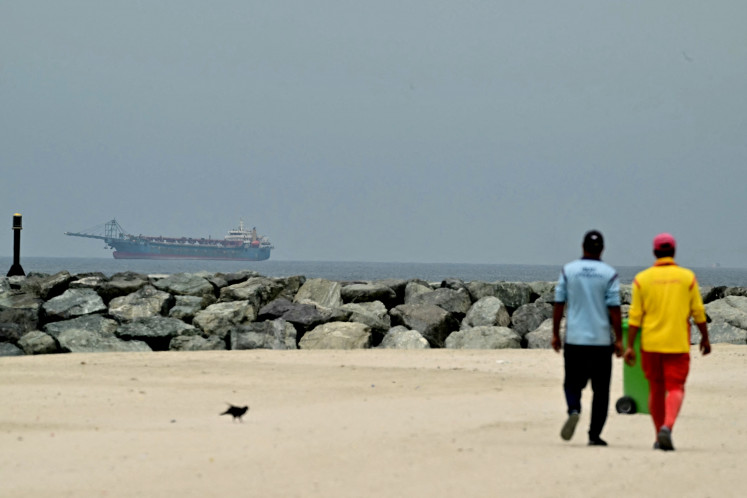Troubled waters: A ship is seen in the Persian Gulf off the coast of Sharjah on Monday, April 13, 2026, the day after the failure of United States-Iran peace talks.