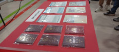Batam Immigration Office displays five Chinese passports and a Malaysian passport (top right) and other documents during a press conference in Batam, Riau Islands, on April 13, 2026. Six foreigners were detained for violation of their stay permits by working in Batam.