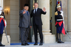 France's President Emmanuel Macron welcomes President Prabowo Subianto prior to their meeting at the Elysee Presidential Palace in Paris on April 14, 2026. 