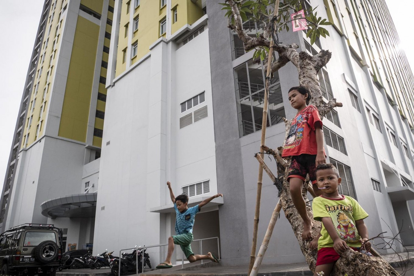 Children play on May 4, 2020, in the yard of the Pasar Rumput Simple low-cost apartment (rusun) in South Jakarta. 
