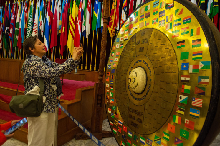 Bandung spirit: A foreign visitor takes a photo of the Asia-Africa Conference gong on April 15 at the Merdeka Building in Bandung, West Java. Inaugurated in 1980, the Asia-Africa Conference Museum receives 400-500 visitors per day and is expected to see an increase during the 71st anniversary of the Asia- Africa Conference from April 18 to 24.