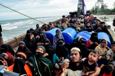 Struggle to survive: Newly-arrived Rohingya refugees look on from their boat on Jan. 29, 2025, after authorities prevented the refugees from disembarking and ordered them to remain on board the vessel, at Leuge Beach in Aceh. Around 250 Rohingya refugees are missing after their boat sank in the Andaman Sea on Tuesday.