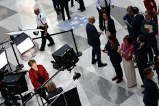 International Monetary Fund (IMF) managing director Kristalina Georgieva (left) gives a television interview on April 15, 2026, during the 2026 IMF and World Bank Group Spring Meetings in Washington, DC.