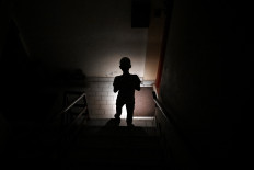Energy crisis: A child uses a mobile phone torch on Wednesday, April 15, 2026, to climb down from his apartment during a power cut in Islamabad. Pakistan suspended electricity supply for about two hours during peak-usage times every evening, the government said, in an effort to manage energy prices affected by the United States-Israeli war on Iran.