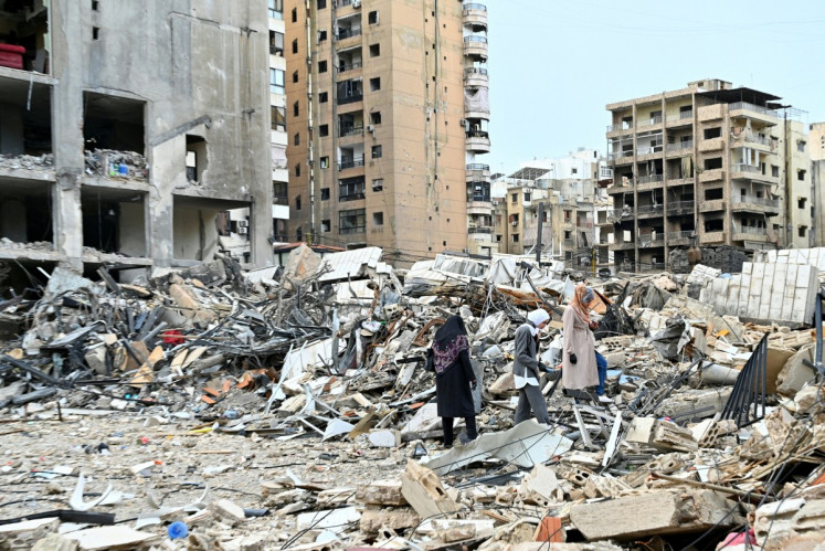 Lebanese women check destruction as they return to their neighborhood in Beirut's southern suburbs after a 10-day ceasefire with Israel came into effect on April 17, 2026. A 10-day ceasefire deal struck between Lebanon and Israel took effect on April 17, sending displaced residents streaming south towards their homes, even as the Lebanese army warned of &ldquo;a number of violations&ldquo; in the area.