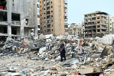 Lebanese women check destruction as they return to their neighborhood in Beirut's southern suburbs after a 10-day ceasefire with Israel came into effect on April 17, 2026. A 10-day ceasefire deal struck between Lebanon and Israel took effect on April 17, sending displaced residents streaming south towards their homes, even as the Lebanese army warned of &ldquo;a number of violations&ldquo; in the area.